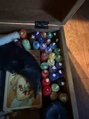 Witchy beeswax mini candles, two sage bundles and assorted black tea lights.